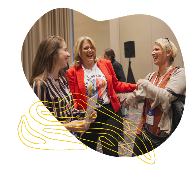 Group of women networking and smiling at a professional event.